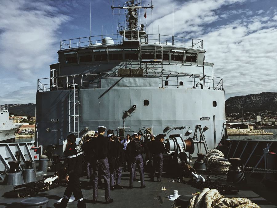 Ship's crew mustered on the foredeck alongside
